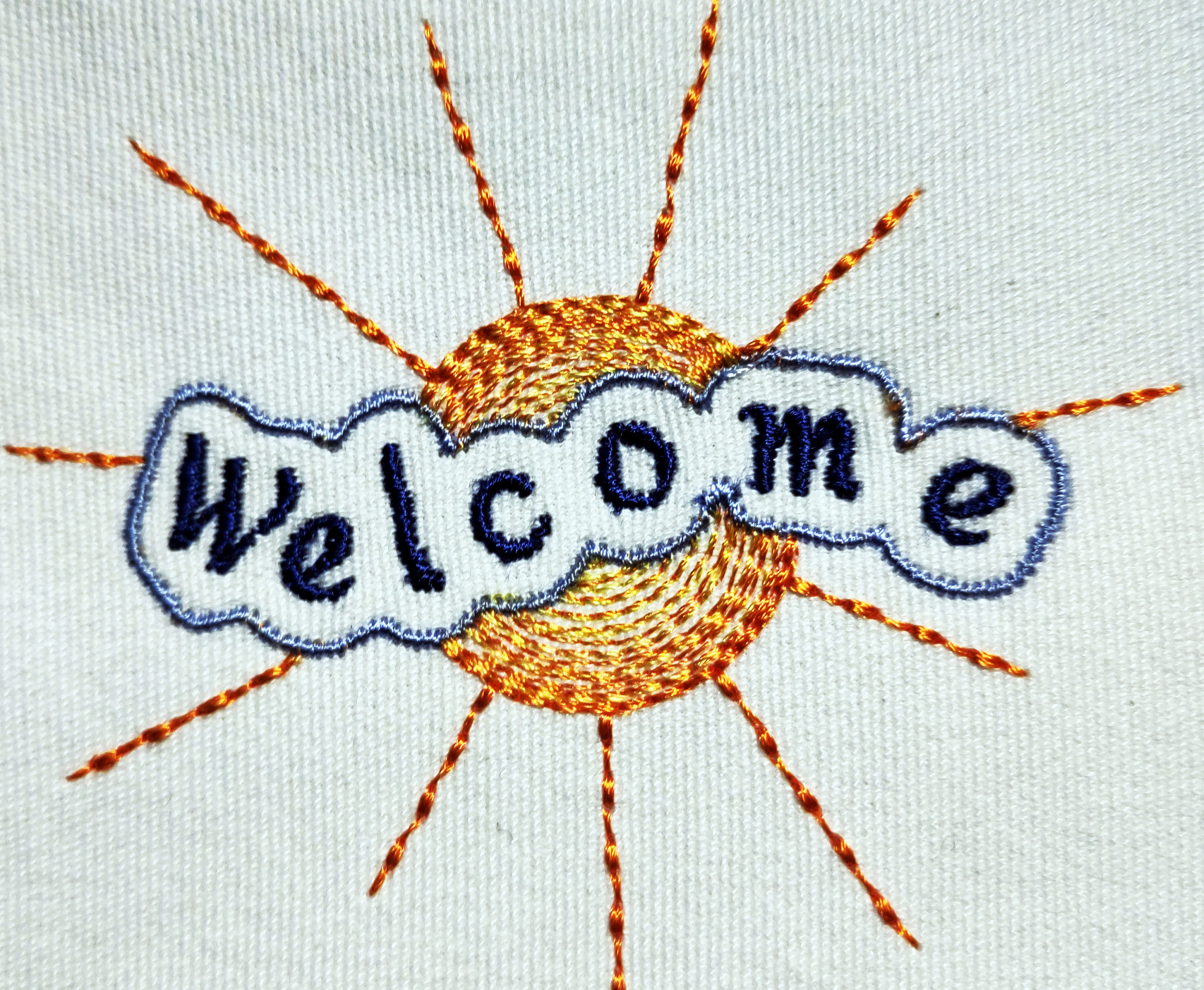 Embroidery stating "welcome"